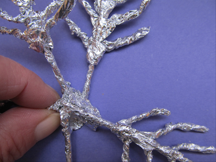 Squeeze and pinch the foil around the center.