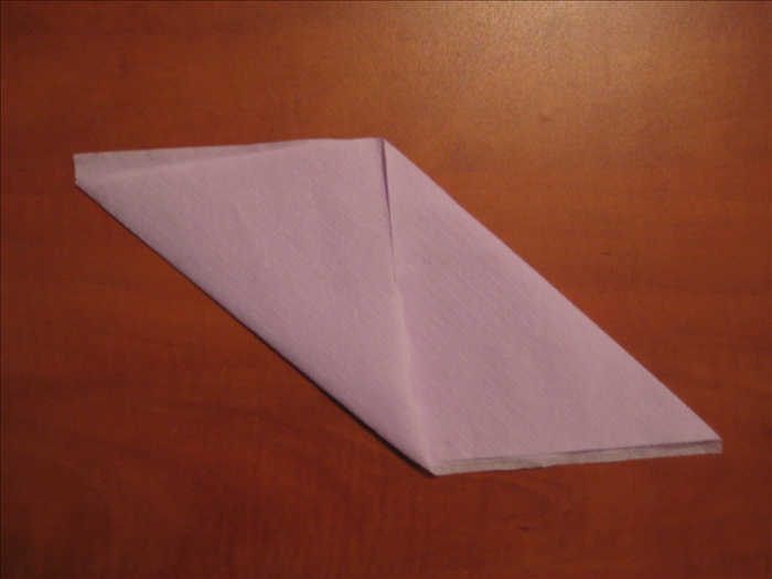 Bring the bottom left corner up to the middle of the top of the napkin
