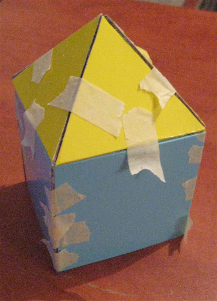 Place the triangles on top of the square base and add more tape as needed.

Let the glue dry completely
