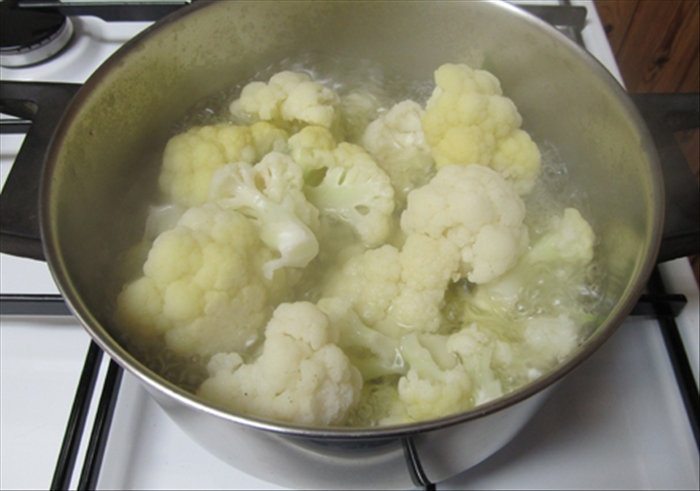 Wash and separate the cauliflower into florets
Boil them in water in a covered pot until they are cooked but firm.
