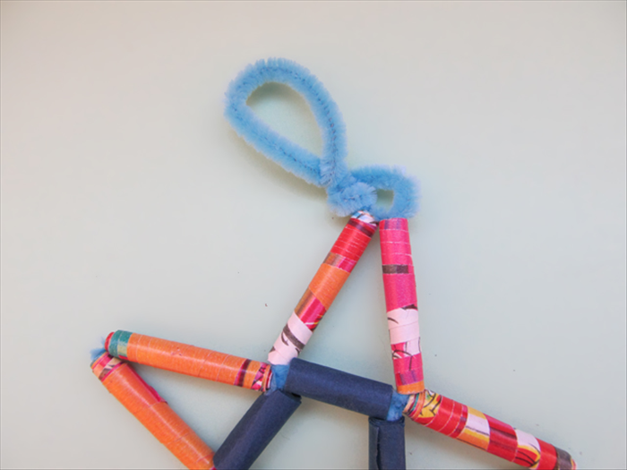 Insert the end of the pipe cleaner into the long bead
Push it in all the way.
