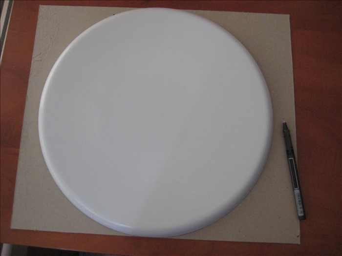 Place a large round serving tray on the cardboard and make an outline around  it.  
Cut out the circle.
Repeat for a large plate and a small plate
