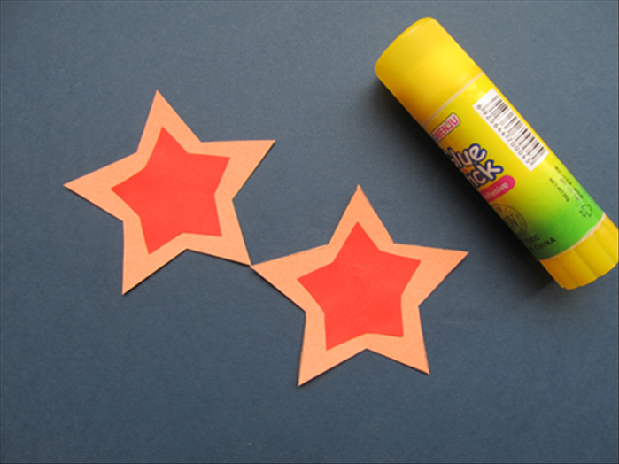 Glue the smaller stars to the center of the larger stars