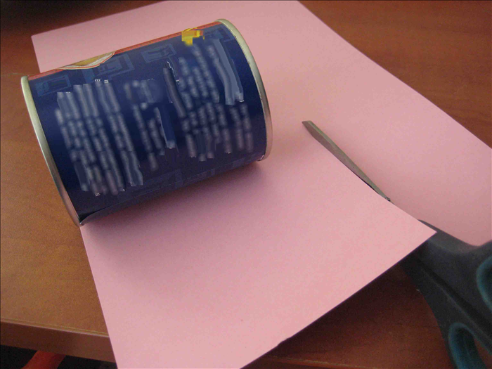 Cut paper  about 1 ½ inches  bigger than the height of 2 cans and long enough to go around