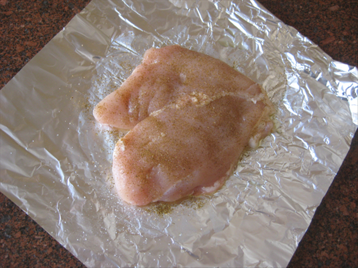 Put the chicken breast on a piece of aluminum foil large enough to fold over it 
Spread some olive oil on both sides of the chicken breast
Sprinkle some salt and if you want add your favorite spice
