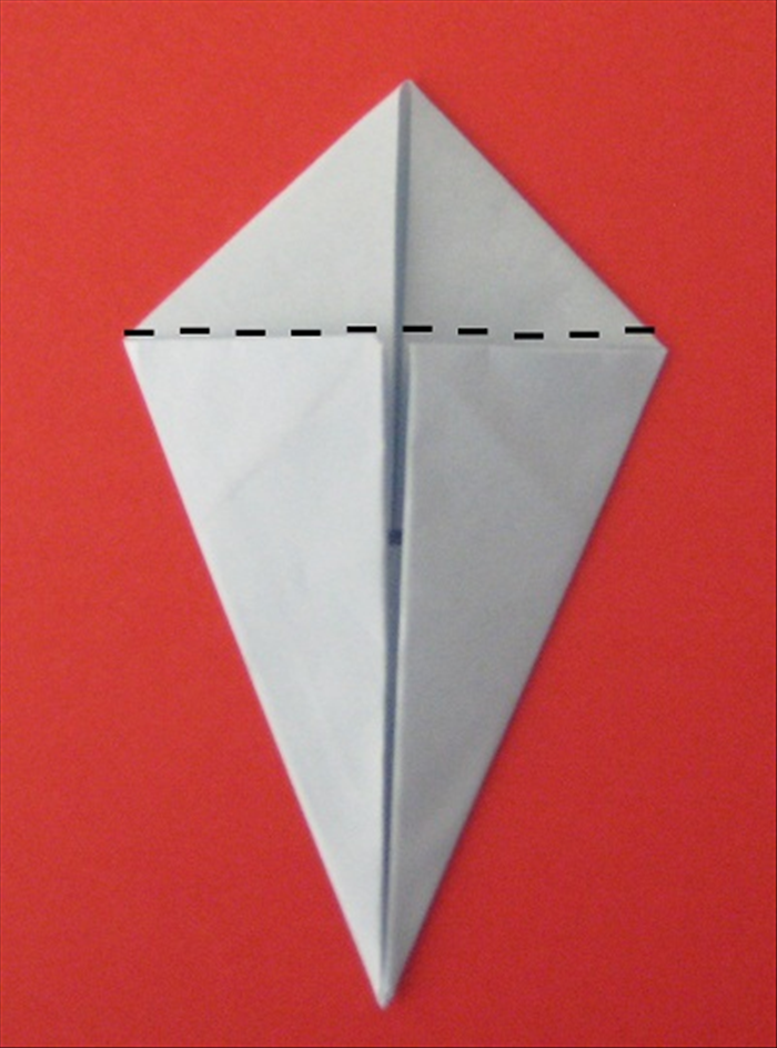 Fold the top smaller double triangle backwards- behind