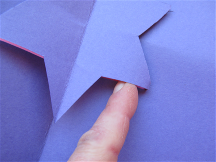 <p> Open up the card and stick your finger under the star to fold the parallel lines down from the bottom.</p> 
<p> Lift the star to push it up from the middle and squeeze the center crease so it will go in the other</p> 
<p> direction.</p> 
<p> Close the card and give it a sharp crease.</p>
