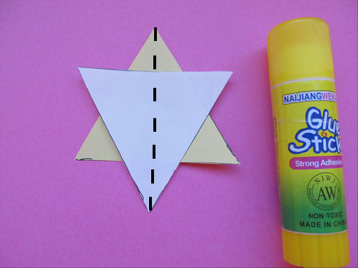 <p> Glue the triangles together to make a star.</p> 
<p> Fold the star in half vertically as shown</p>