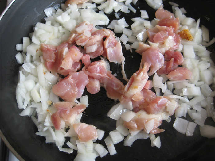 <p> Sauté the onion in 2 tablespoons oil for about 2 min.</p> 
<p> Add any uncooked chicken or turkey you might be using and stirfry until the pieces turn white</p>