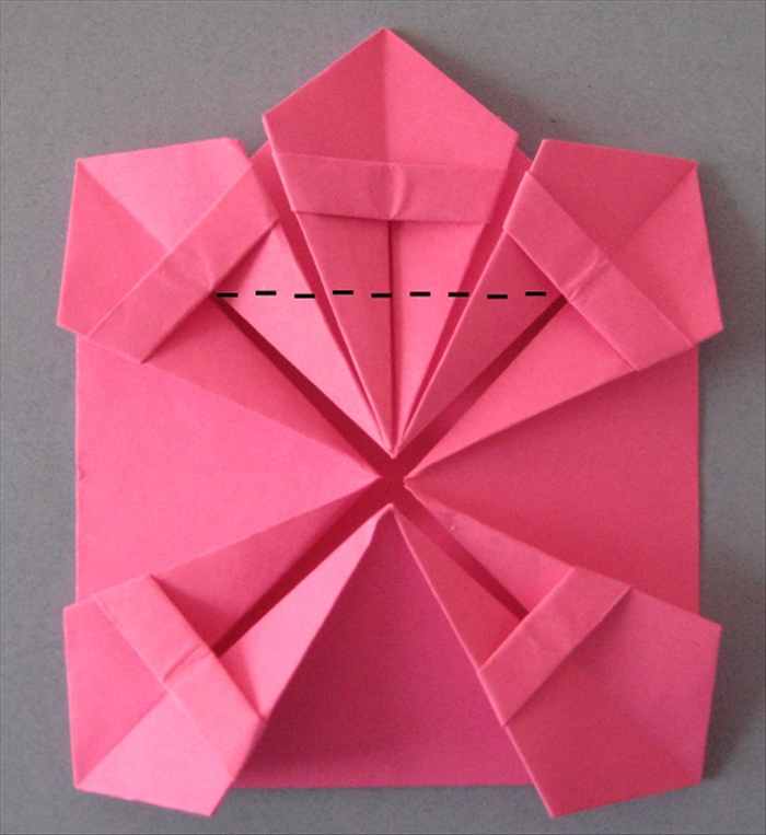 Pick up the flaps of  2 side of the “kites” and slide the peice in as far as it will go.
Fold the 3 points up.
