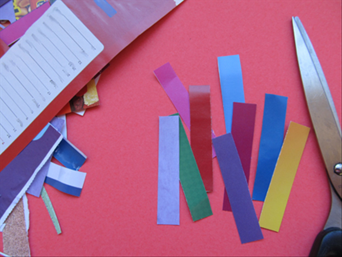 Choose colored areas of your junk mail.
Cut out 9 strips about 1 ¾ inches wide and 2 ½ inches long