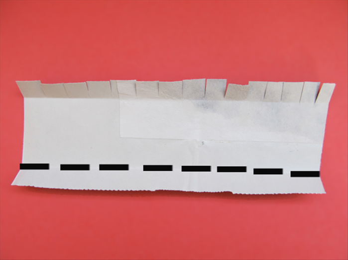 Make a ½ inch fold on the opposite edge.