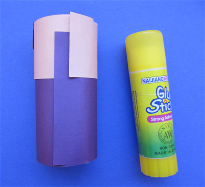 Wrap the base around the toilet paper roll and glue the ends together