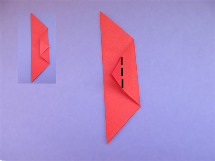 Fold the point to the opposite edge
Make a sharp crease and unfold
