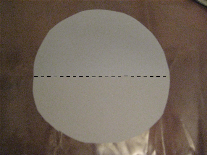 Trace and cut out another circle on a piece of scrap paper  
    
Fold the circle in half horizontally
