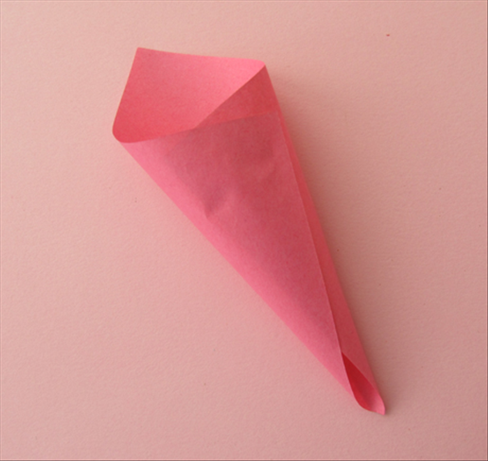Bring the opposite corner over on the glue to make a cone shape 