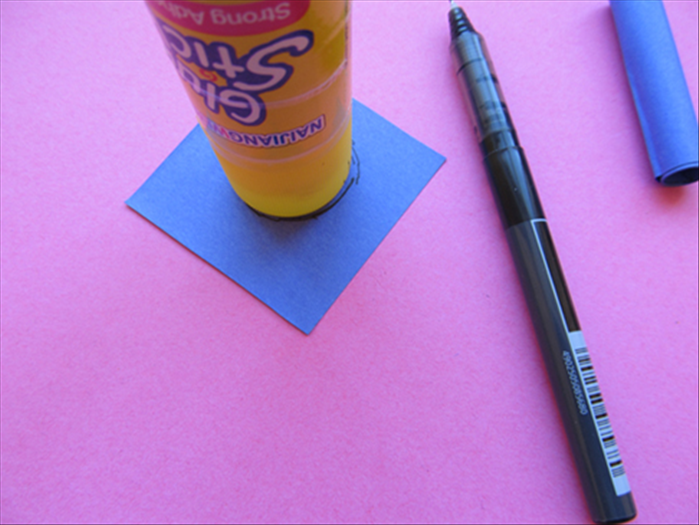 Trace a round circle from the glue stick if it is a large one,  if not use a bottle cap.

Cut out the circle.
