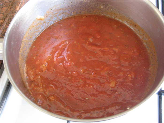 First make the sauce
Fry onion in 2 tablespoons oil until translucent.

Add the garlic and fry another minute

Add tomato paste, salt, pepper, oregano and basil

Bring to a boil, add basil and turn off the heat
You can add a little water but the sauce should be thick
