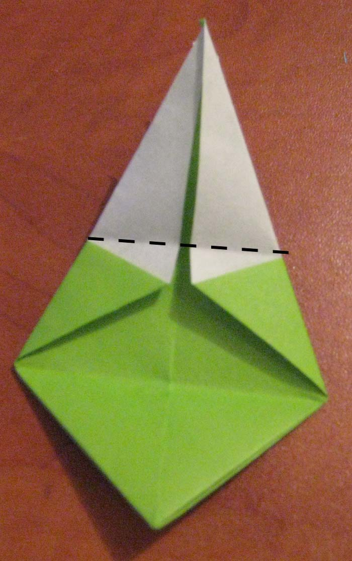 Bring the top point down to the bottom to fold in half.
Make a sharp crease and unfold.