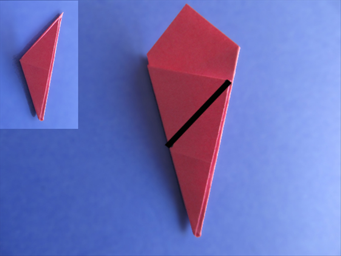 <p> Rotate the paper so that the long point is at the bottom.</p> 
<p> The folded edge should be on the left side.</p> 
<p> Make a straight cut from the middle of the left edge to the right tip of the flap.</p> 
<p>  </p>
