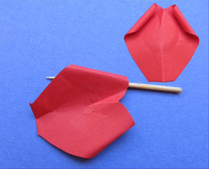 Pinch the straight bottom of the petal.
Roll the round tops backwards.

Repeat on all the petals
