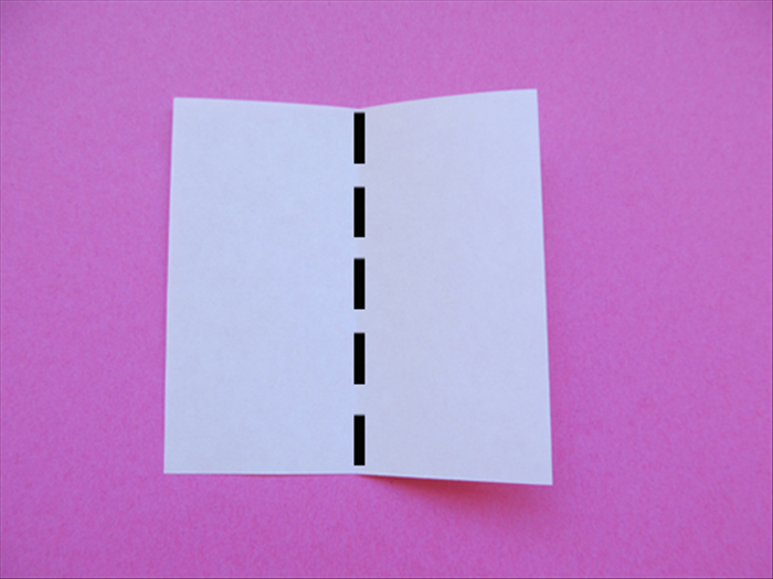 <p> Fold one of the small square papers in half vertically</p>