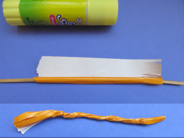 <p> Roll up the paper on the skewer. When you get to the end of the roll put glue along the edge. Do not put glue where the fringe is.</p> 
<p> Remove the rolled paper from the skewer.</p> 
<p> Twist it up to the fringe.</p> 
<p>  </p>