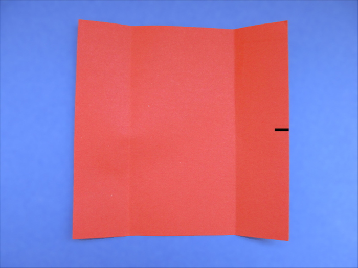 <p> Bring the bottom edge up to the top edge as if you are going to fold it in half. Do not crease just make a pinch mark at the edge.</p>  
<p>  </p>