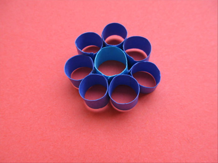 Glue 5 - 7 petals around the center roll. 