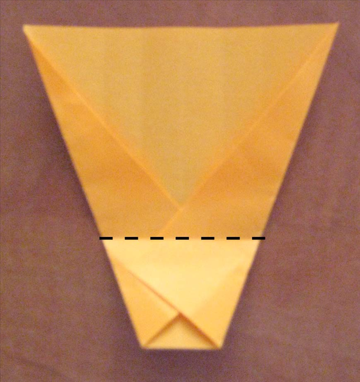 Turn the paper so that the narrow part in on the bottom . 
Fold the narrow bottom edge up about 1/3. of the way.
