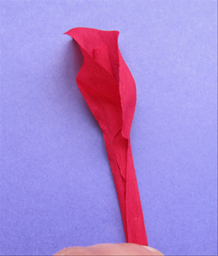 Take a stretched petal and place it with the curled edge facing outwards and a little higher than the first petal.
Bring the sides around the wire.