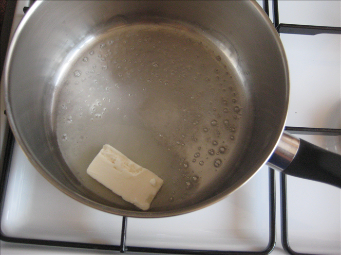 Melt the butter or margarine in a pot over low heat