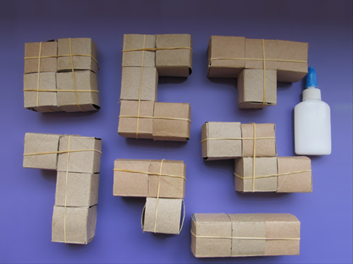 <p> Carefully glue the cubes together as shown in the picture.</p>  
<p> Use the rubber bands to hold them together until the glue dries.</p>  
<p>  </p>