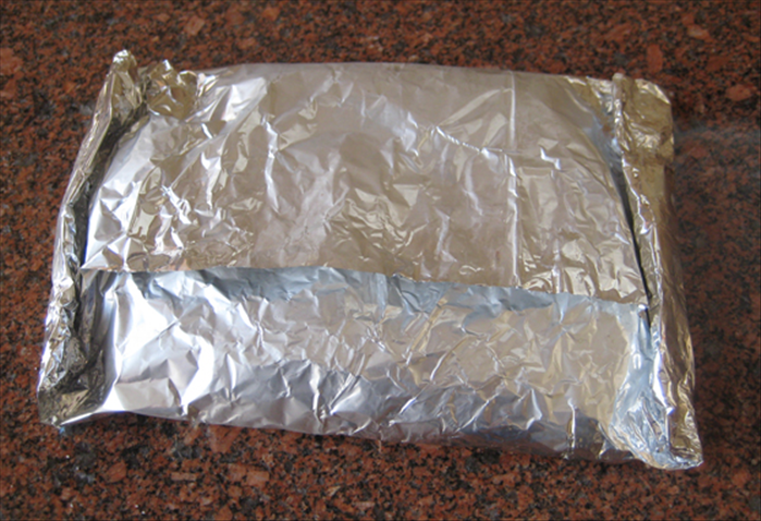 Wrap the aluminum foil around the chicken and fold over the ends