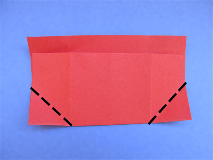 <p> Rotate the paper so that the folded edge is on the bottom.</p> 
<p> Fold the bottom corner to align with the creases.</p>