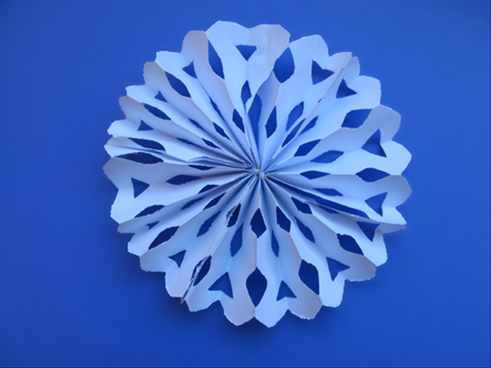 Your snowflake fan decoration is ready to hang
Have fun experimenting with different cuts!

