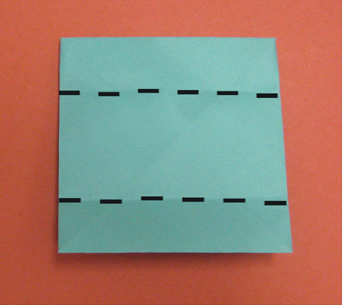 Flip the paper over to the back side.
Fold the top  and bottom edges to the center crease. 
 Let the flap underneath popup. 
See the next picture for result
