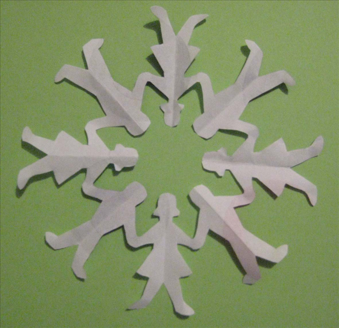Carefully open the folds to see your finished circle of paper dolls.