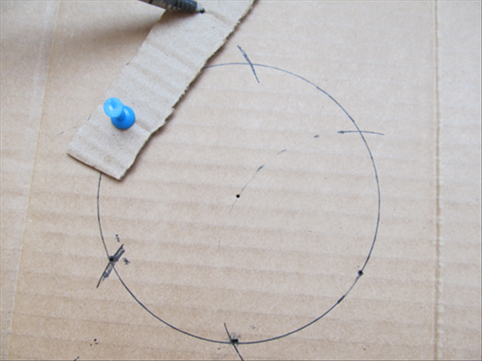 Put a pin through a hole in the strip and into the hole you just made in the circle
Put the pen in the second hole and rotate to mark the circle.
You now have 6 marks on the circle of equal distance
Remove the strip
