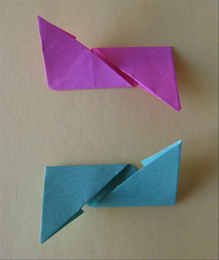<p> You should have the 2 papers folded in the opposite directions as shown in the picture.</p>