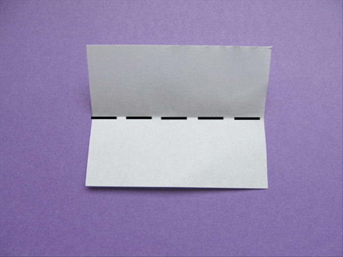 Place the rectangle paper with the short ends at the sides. If it is colored on one side, place the colored side facing down

Bring the top edge down to the bottom edge to fold it in half.

