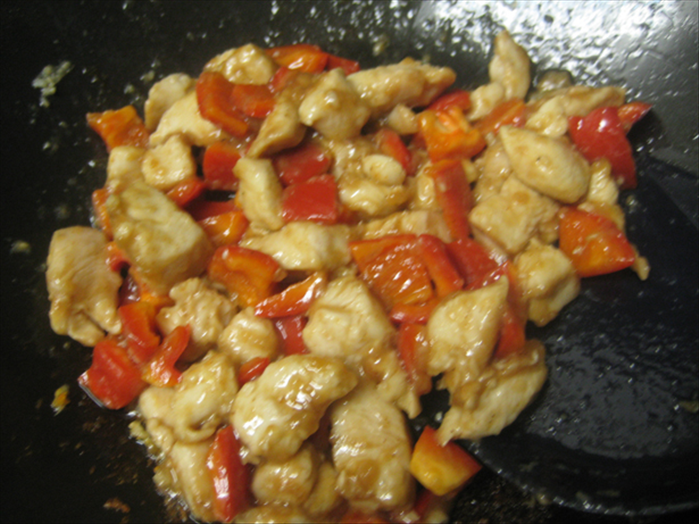Add the cooked chicken pieces and pour in the cooking sauce
Stir fry until sauce thickens
