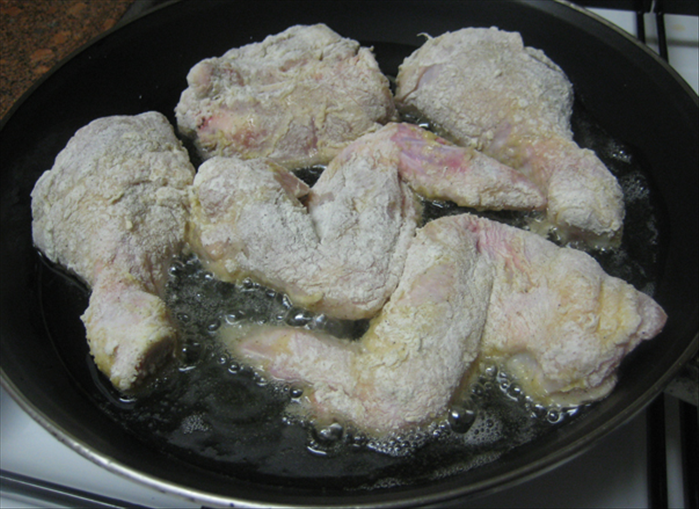 Brown chicken pieces bottom side down  in oil heated on a low flame. Fry slowly for 15 min.
Do not turn over or play with the pieces. 
