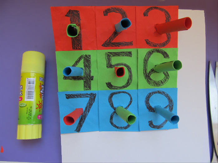 Glue number 4 -9 the same way you did number 3.
Cut the cardboard along the outside edge of the numbers
And your desktop pegboard game is ready for play.
Enjoy!
