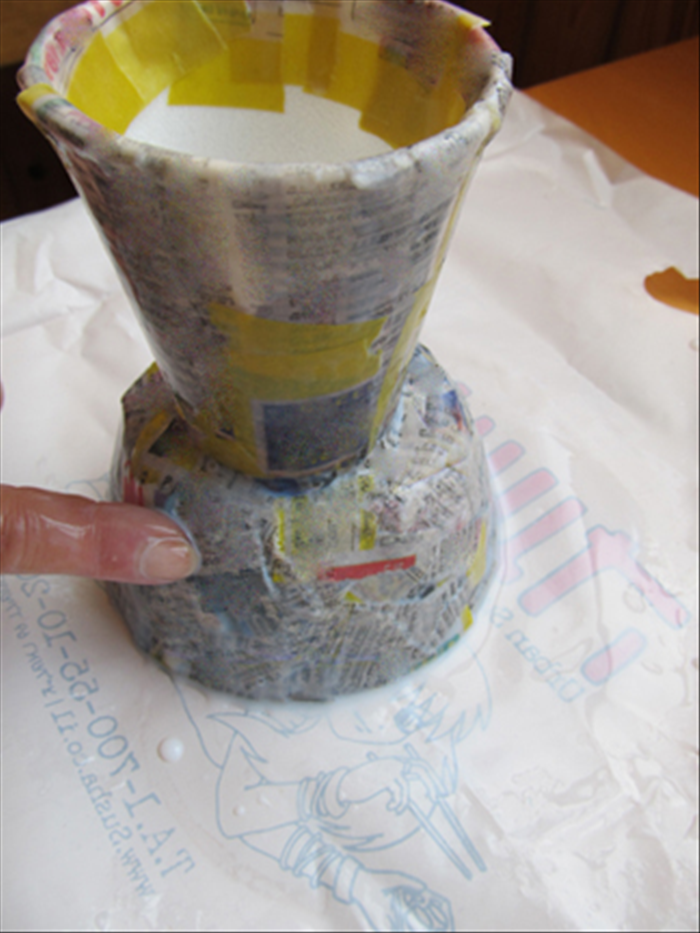 Put at least another 2 layers of strips on the vase.
Use your finger to smooth them out.