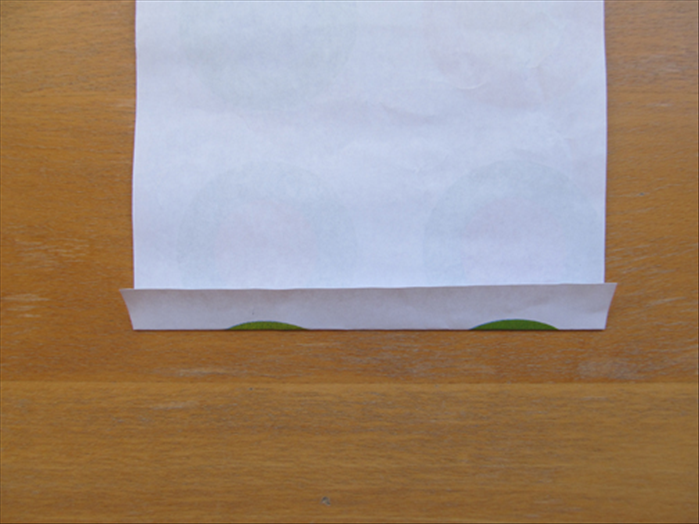 Turn the paper so that the short edges are at the top and bottom.
Make a fold about ¾ inch 
