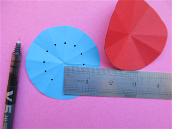 To make different variations measure a different distance from the center along the crease lines for each pair of circles. 
In the variation show in the next picture a dot was marked 1.5 inches from the center.
