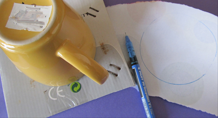 Trace a circle around the large coffee cup on a piece of cardboard and a piece of scrap paper