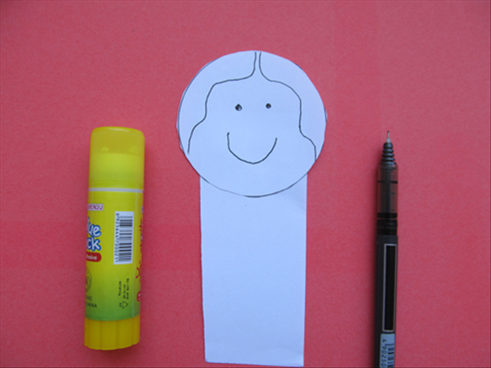 Glue the circle to the top of the paper strip and draw the face and hair
You can use colors for the head 
