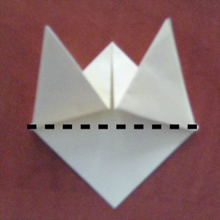 Fold the bottom layer up where it meets the outside edges of the two triangles above it.